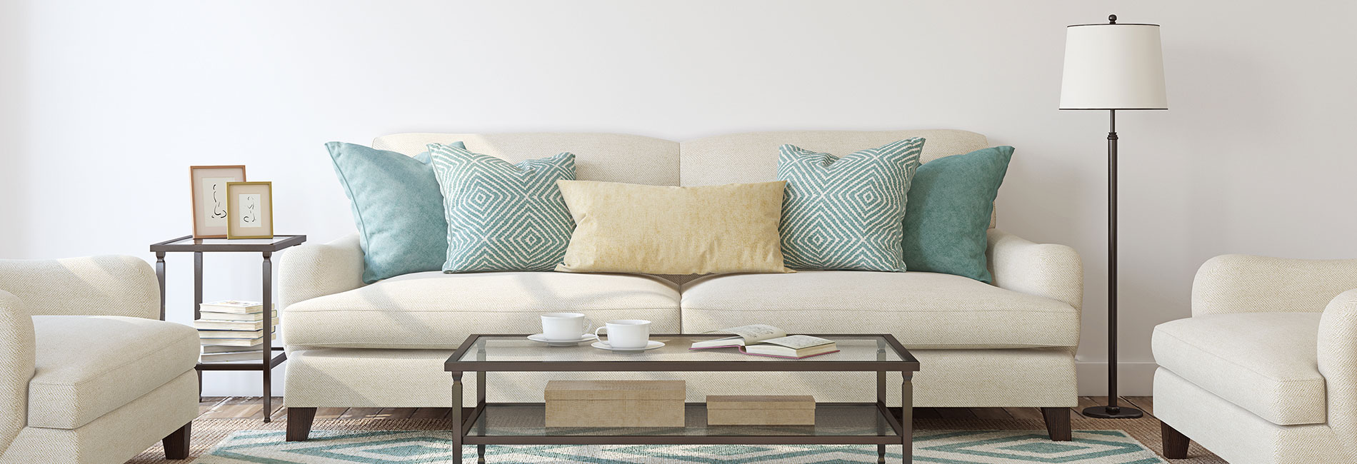 a white couch with blue pillows and a blue coffee table at The Westmount at Copper Mill