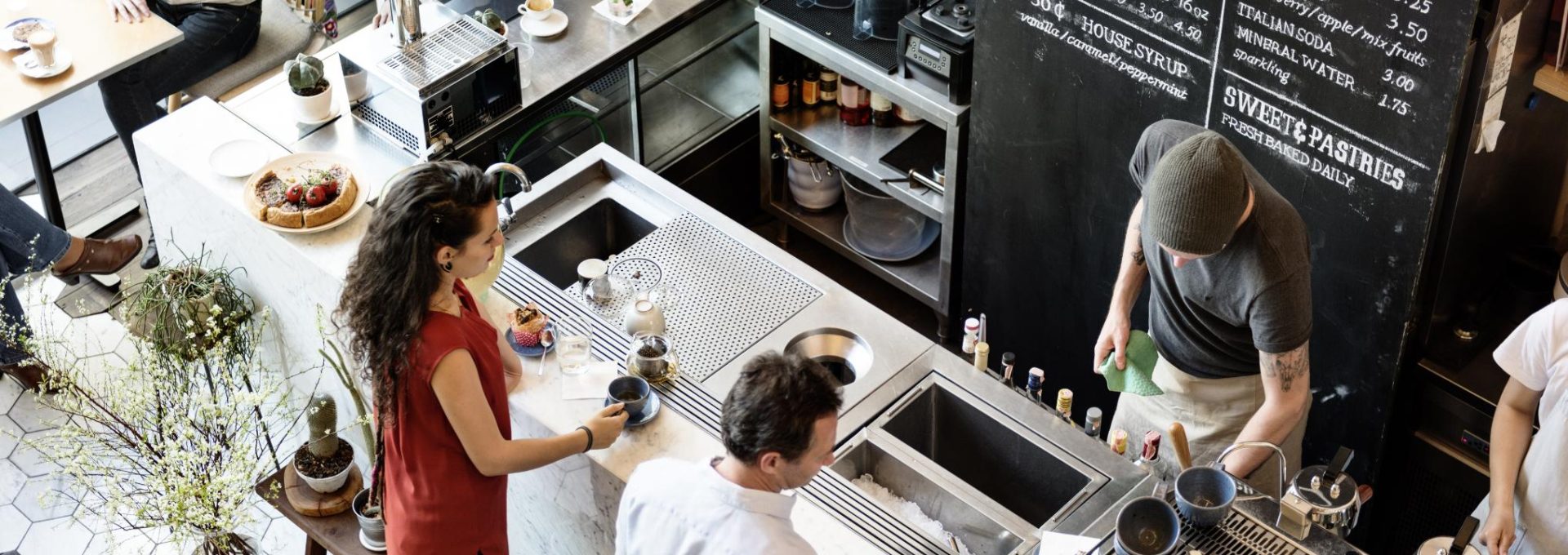 a group of people are standing around a counter at The Westmount at Copper Mill