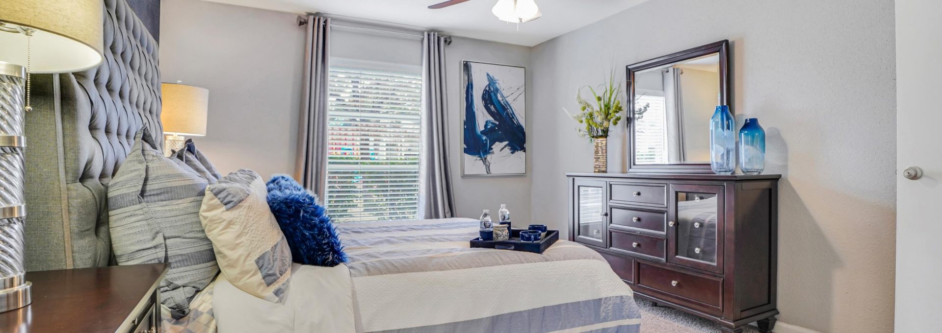 a bedroom with a ceiling fan and a bed at The Westmount at Copper Mill