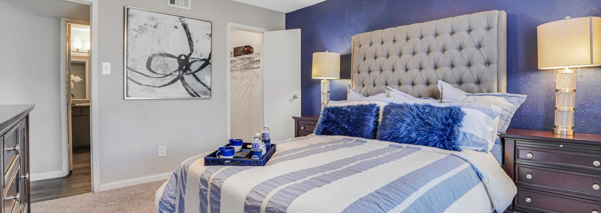 a bedroom with blue walls and ceiling fan at The Westmount at Copper Mill
